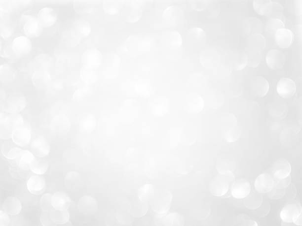 istock Light Bokeh Effect Sparkle Grey White Dust Texture Flare Glitter Glow Background Blur Abstract Card Party Holidays Celebrate Festive Soft Silver Pattern Banner Season Winter Wallpaper Magic Dust. 1906291978