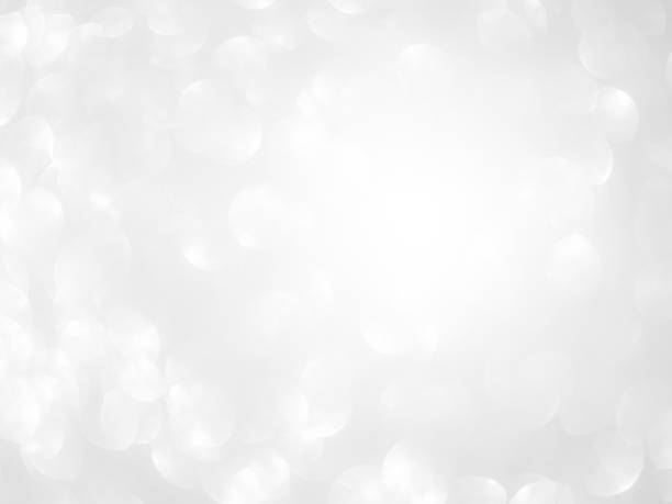 istock Light Bokeh Effect Sparkle Grey White Dust Texture Flare Glitter Glow Background Blur Abstract Card Party Holidays Celebrate Festive Soft Silver Pattern Banner Season Winter Wallpaper Magic Dust. 1906291981