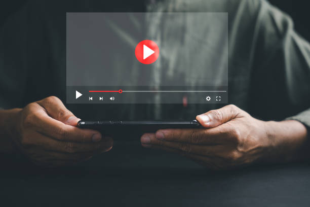 Man enjoying video streaming on virtual screen with a smartphone