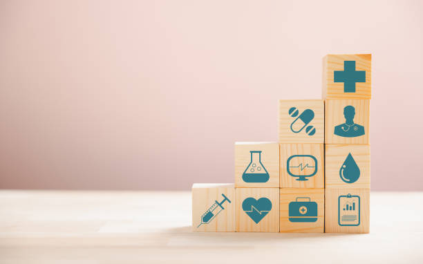 istock Medical symbols on wooden blocks stacked 1906321321