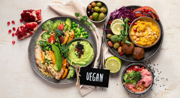 istock Vegan tasty hummus, herb hummus, beetroot hummus on a light wood background. 1906351681