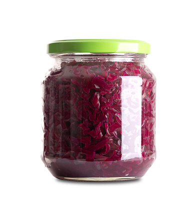 Red cabbage, homemade fermented German Blaukraut in glass jar with lid. Raw red cabbage, fermented by lactic acid bacteria. Unpasteurized, uncooked blaukraut provides probiotics, improving digestion.