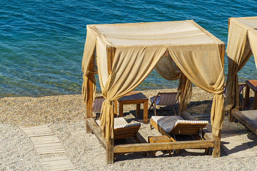 Luxury beach tents with awnings on pebble beach of Gelendzhik. Beautiful resort on the Black Sea in southern Russia.