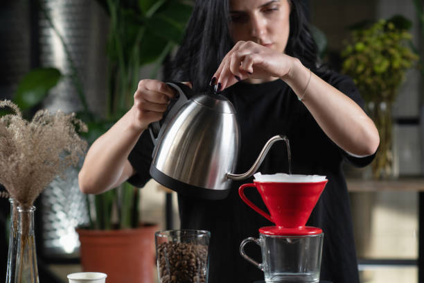 istock Female Barista Expertly Prepares Drip Coffee 1906407790