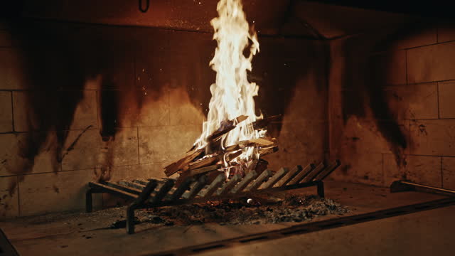 SLO MO Handheld Shot of Fireplace with Burning Wood Logs at Home During Winter