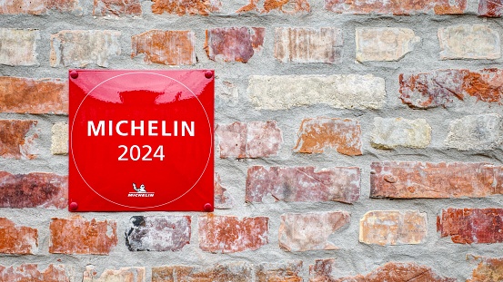 Liepaja , Latvia - January 03 2024 : Michelin 2024 red star book Guide plate text sign with logo brand on good Restaurant Wall building