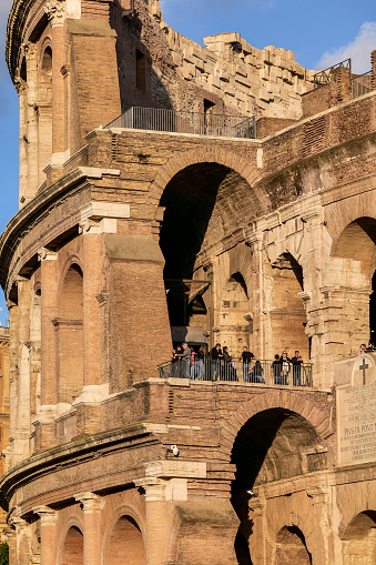 Rome, Italy, November 11 -- A particular and suggestive glimpse of the Colosseum in the center of the Roman Imperial Forum, in the historic heart of Rome. The majestic Flavian Amphitheatre, known as the Colosseum due to a colossal statue that stood nearby, was built in the 1st century AD. at the behest of the emperors of the Flavian dynasty, and hosted, until the end of the ancient age, shows of great popular appeal, such as hunting with exotic animals, gladiator fights and even evocations of historical naval battles. The Roman imperial Forum, one of the largest archaeological areas in the world, represented the political, legal, religious and economic center of the Ancient Rome, as well as the nerve center of the entire Roman civilization. In 1980 the historic center of Rome was declared a World Heritage Site by Unesco. Image in high definition quality.
