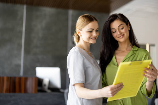 istock Nurse talks with a woman in lobby 1906478421