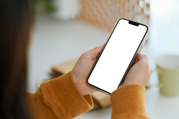 istock Closeup woman hands holding mobile phone with empty screen for application advertising. 1906485713