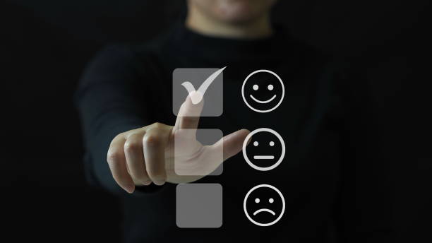 istock Customer service and Satisfaction concept ,Business people are touching the virtual screen on the happy Smiley face icon to give satisfaction in service. rating very impressed.Customer service satisfaction rating 1906488931
