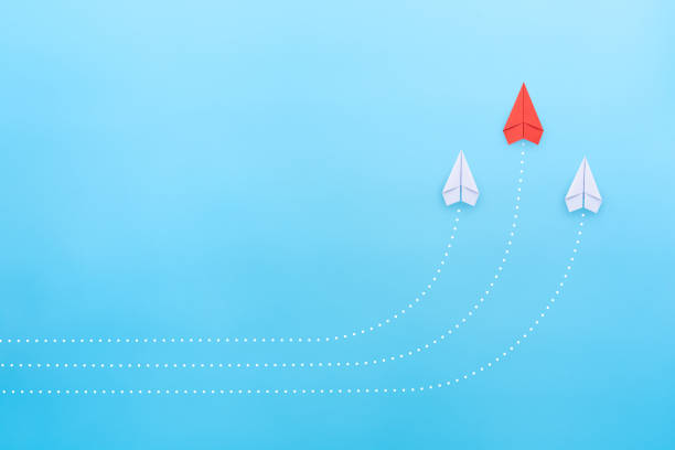 istock Leadership concept with red paper plane leading among white paper planes on blue background. copy space 1906489343
