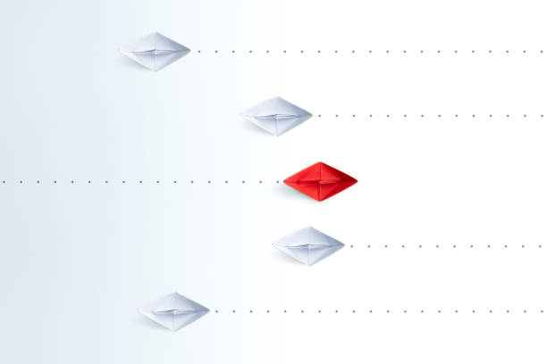 istock Red paper ship pointing in different way among white paper ships on white background. New idea, Unique way and Business for innovative solution concept. 1906490384