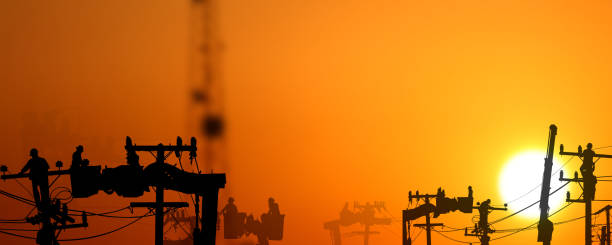 istock group of silhouette electric worker working on pole connected high voltage transmission line with  high volttag transmission towers 1906493470