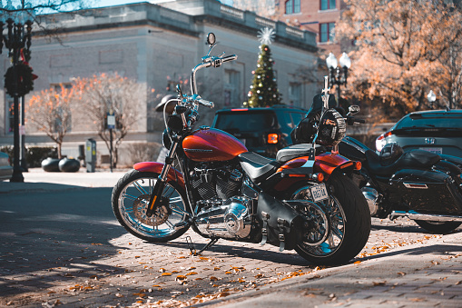 Fayetteville, United States – December 13, 2023: The two motorcycles parked on the side of a road in downtown Fayetteville, North Carolina.
