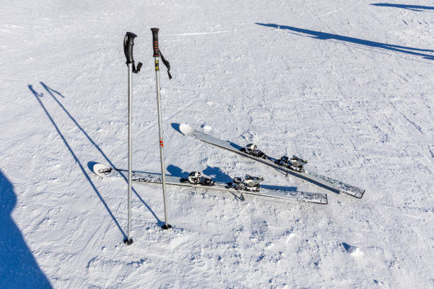 ski poles on a snowy slope on a sunny day in the alps