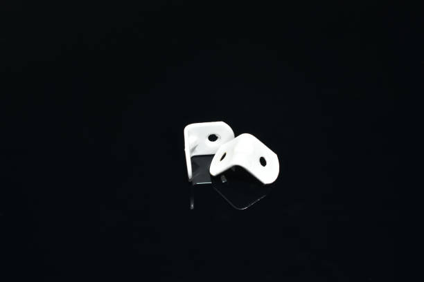 istock White metal corners lie on a black background. 1906510105