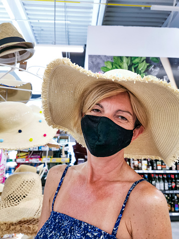Woman on Vacation in Summer Wearing Protective Face Mask on a Walk Around Town