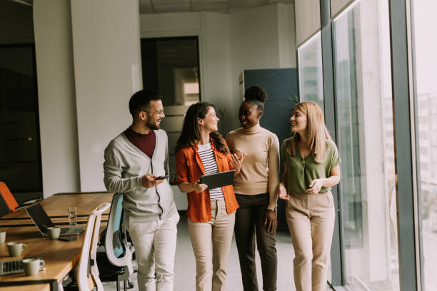 istock Young multiethnic startup team walking in the modern office 1906577692