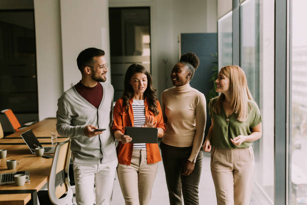 istock Young multiethnic startup team walking in the modern office 1906577694