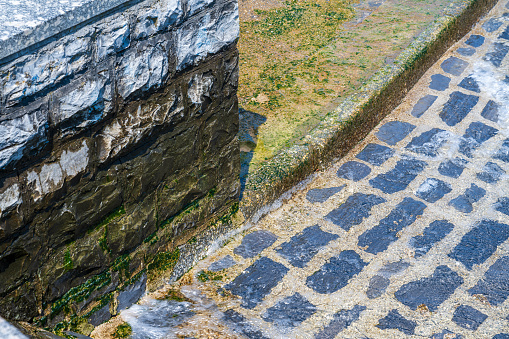 Brick barrier and walkway along Lake Como, at Como, Italy on a summer day.