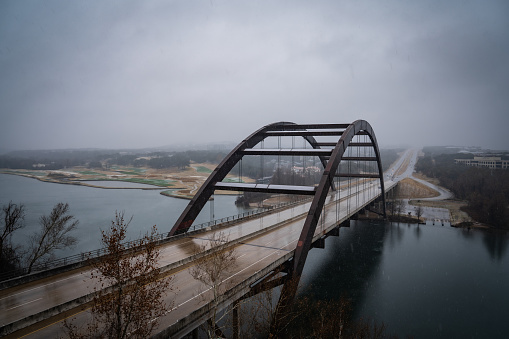 A stunning view of the Pennybacker Bridge in Austin, Texas during a snowstorm