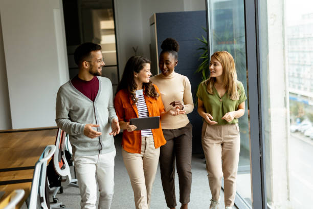 istock Young multiethnic startup team walking in the modern office 1906614414