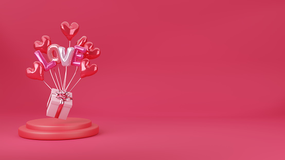 Front view of a levitating gift box being holded by various heart shaped balloons. Objects are at the left of the image leaving a useful copy space at the right side on a pink background