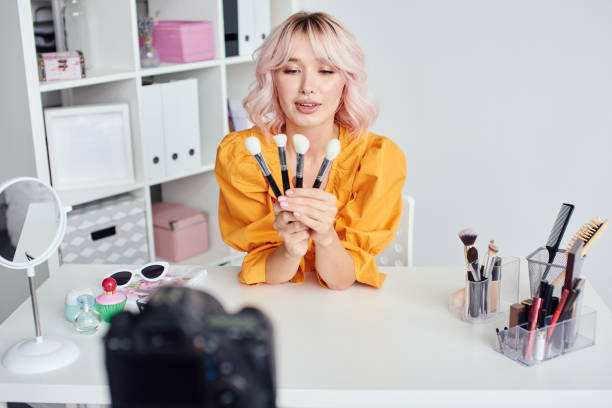 istock Woman with cosmetic brushes in hands 1906623348