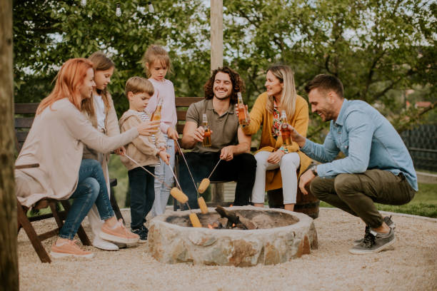 istock Friends having good time and baking corns in the house backyard 1906623671