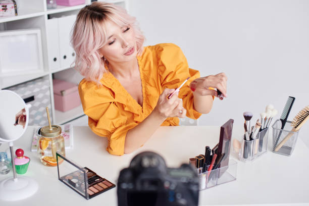 istock Pretty woman testing lipstick for beauty blog 1906623901