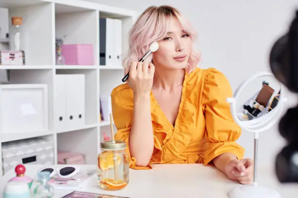 Photo of Pretty asian blond woman doing make up