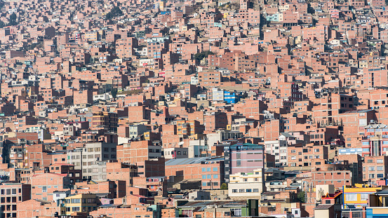 La Paz, Bolivia - 6 September 2017: Mass housing with rows of buildings tightly packed on the hillsides. These structures, often simple and compact, accommodate a significant population