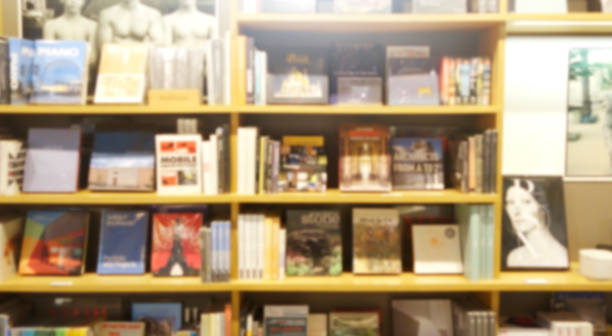 Blur background of book shelf store decorated with wood and warm light Blur background of book shelf store decorated with wood and warm light. bookstore stock pictures, royalty-free photos & images