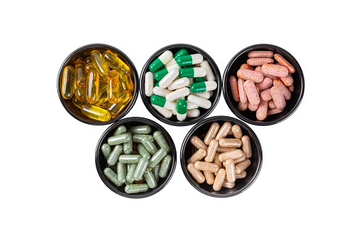 Vitamins and supplements. A variety of vitamin tablets  isolated on a white background. Multivitamin complex for every day. Nutritional supplements.Copy space.Vitamins for immunity