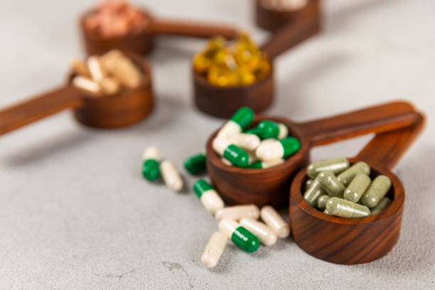 istock Vitamins and supplements. Variety of vitamin tablets on a textured background. Multivitamins with fresh and healthy fruits. Nutritional supplements. Flat layout. Place for text. Copy space 1906693311