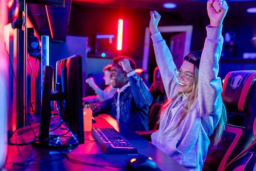 A vibrant scene capturing two players, one black and one white, celebrating a triumphant moment in a competitive eSports match, showcasing the exhilaration of shared success