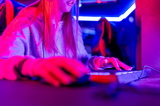 The photo focuses on a gamer's hands, engaging rapidly with a keyboard in a live eSports broadcast, showcasing the excitement and skill in the world of competitive gaming