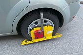 parking penalty fee or penalty. A Wheel Clamp Boot On Wheel of Car. Illegal parking on wrong street place