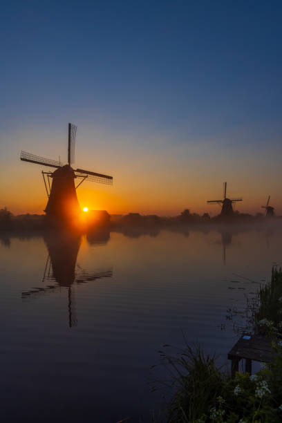 istock Traditional Dutch windmills with a colourful sky just before sunrise in Kinderdijk, The Netherlands 1906753312