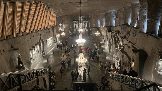 Visitors explore the enchanting St. Cunegunda Chapel, carved entirely from salt, illuminated by stunning chandeliers