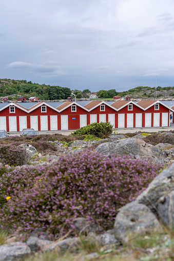 A scenic view of a group of traditional red and white houses in Munkkyrkan, Smoegen, Sweden