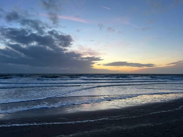 istock Tranquil beach scene at dusk featuring a low tide shoreline 1906767962