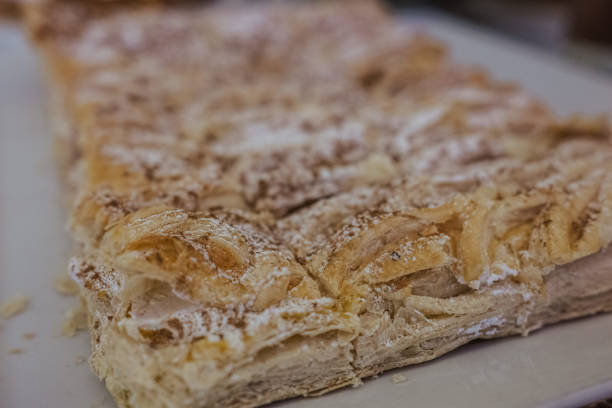 istock Freshly-baked, square-shaped pastry dusted with powdered sugar 1906770251