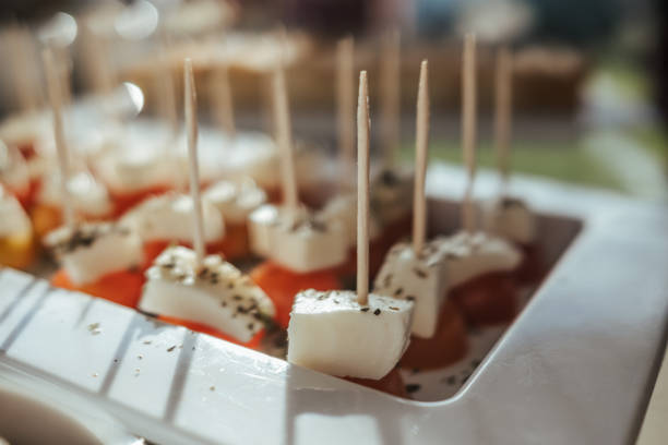 A plate of cheese appetizers on toothpicks