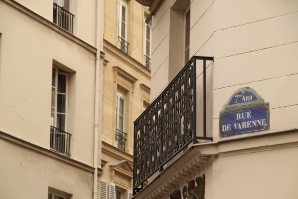 istock Ornate wrought iron railing overlooking a white building with signage on the balcony in Paris 1906770867