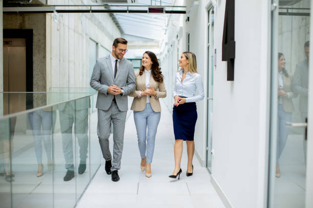 istock Young startup team have a discussion while walking in the modern office corridor 1906772029