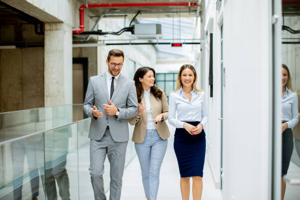 istock Young startup team have a discussion while walking in the modern office corridor 1906772040