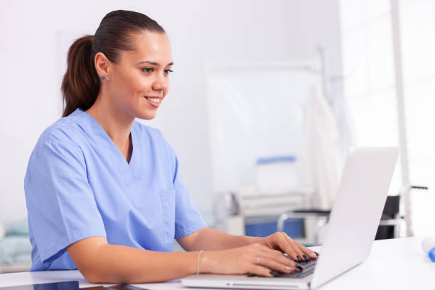 istock Medical nurse in uniform using laptop 1906777856