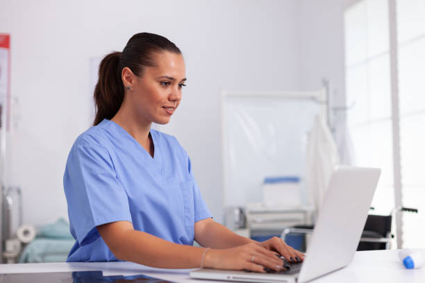 istock Medical nurse in uniform using laptop 1906789885