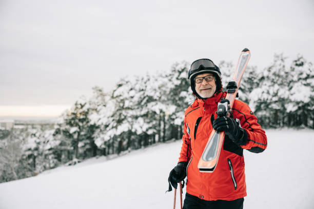 istock Active senior man walks with skis on his shoulder 1906790919